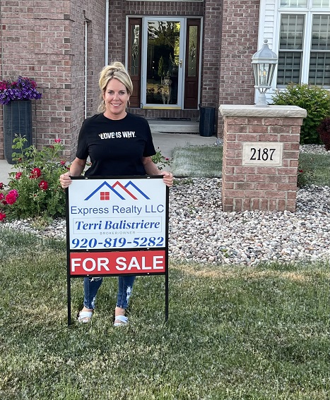 Terri Balistriere, broker/owner of Express Realty, stands by a for sale sign and offers 6 tips to selling a home 